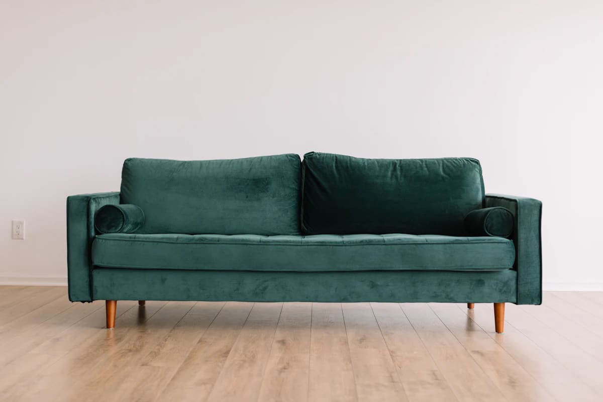 Linen sofa with a solid walnut frame in a bright room