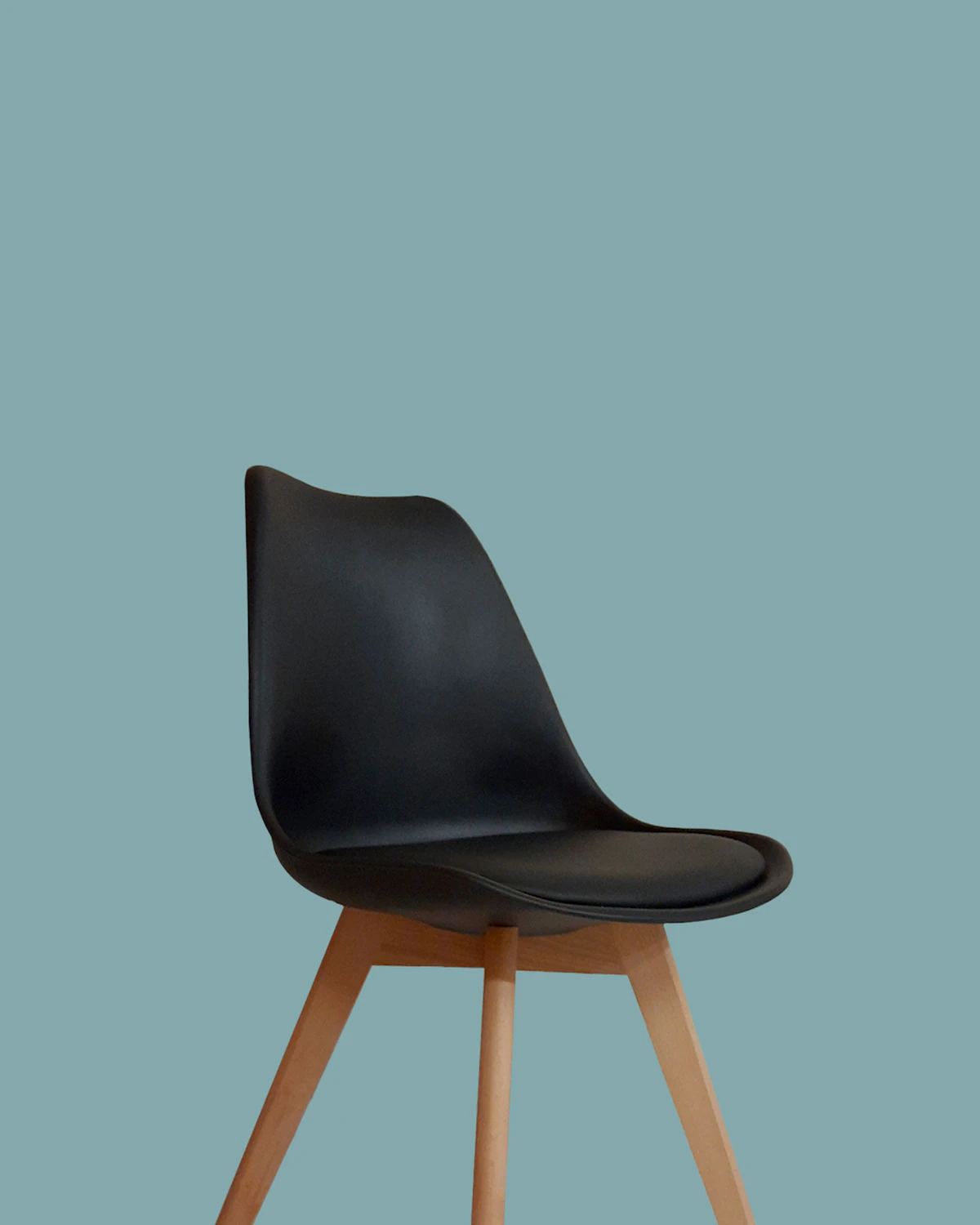 Black moulded shell chair with wooden legs