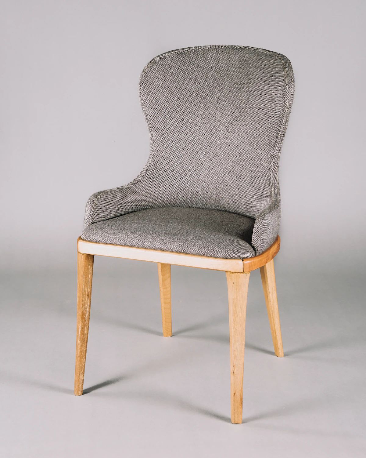 Grey wool-upholstered dining chair with oak legs